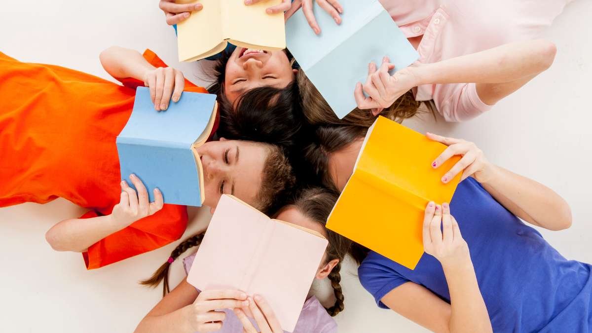 Crianças lendo livros na sala – incentivo à leitura